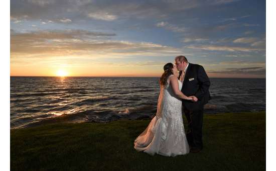 bride and groom on the ocean shoreline