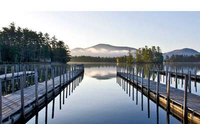 docks on lake george in calm morning waters