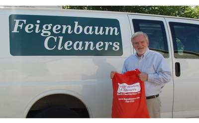man standing in front of feigenbaum cleaners van