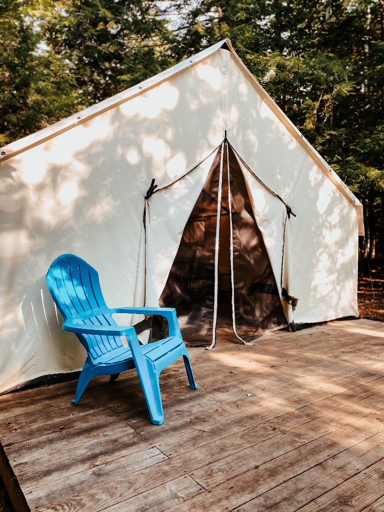 A wall tent with a blue chair