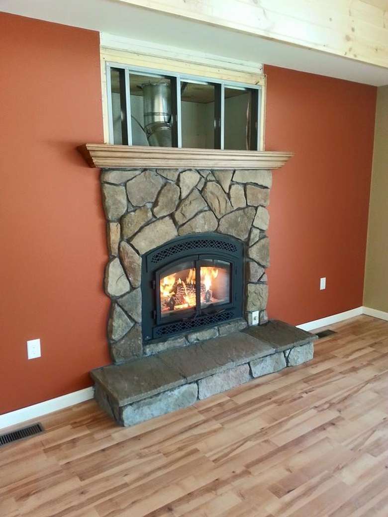 Stone fireplace against wall