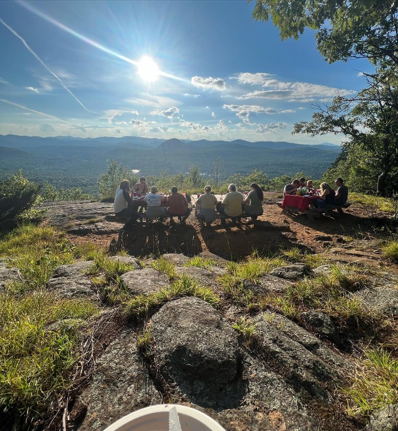 people eating at picnic tables at a summit
