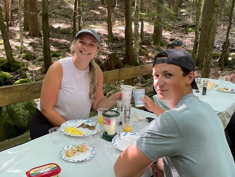 man and woman at a breakfast table outdoors
