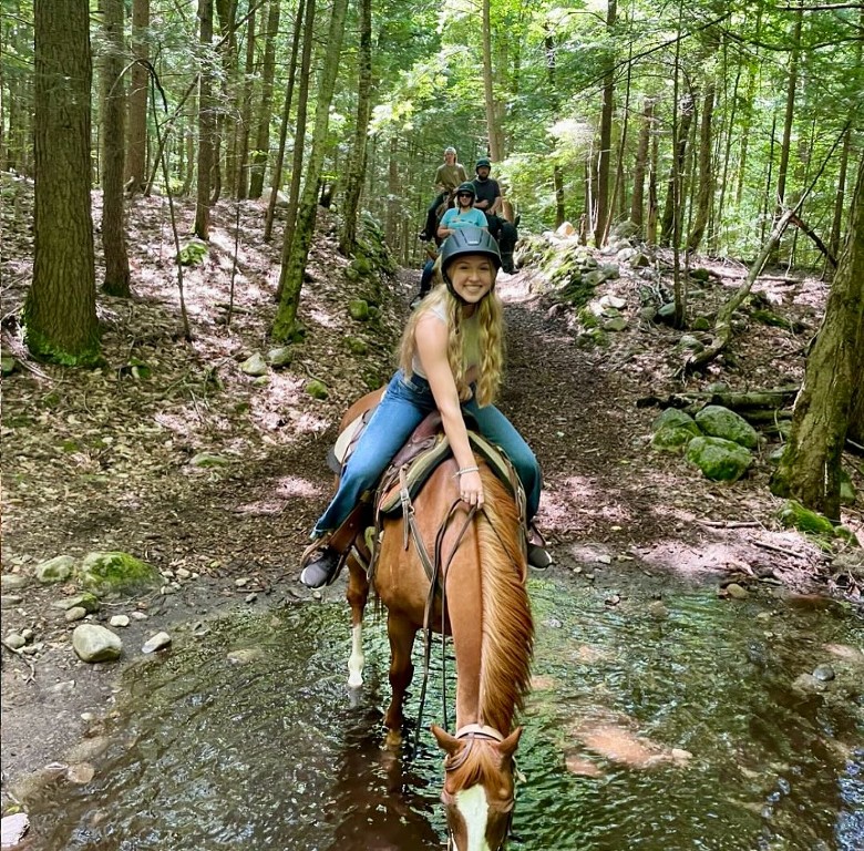 horseback riding in the woods