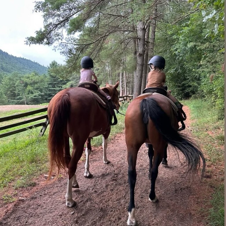 two girls horseback riding