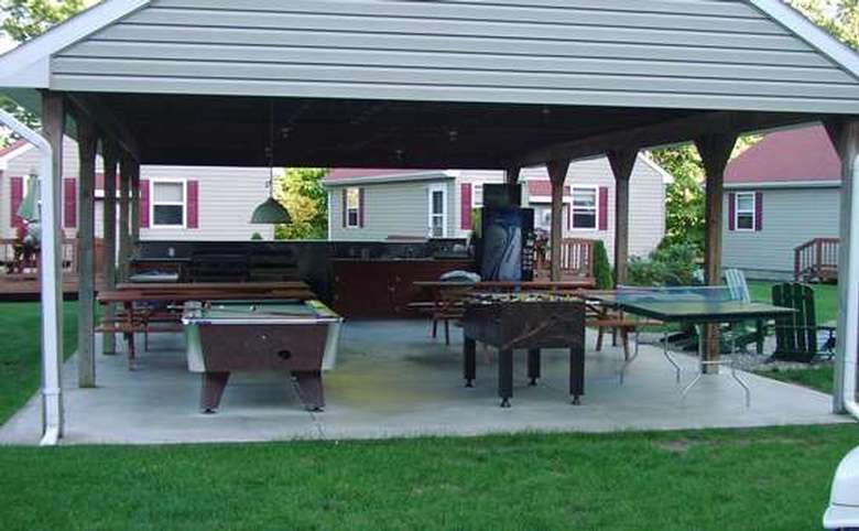 covered outdoor area with picnic tables, pool table, foozeball