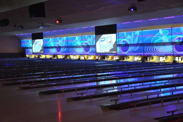 bowling lanes with illuminated images above them