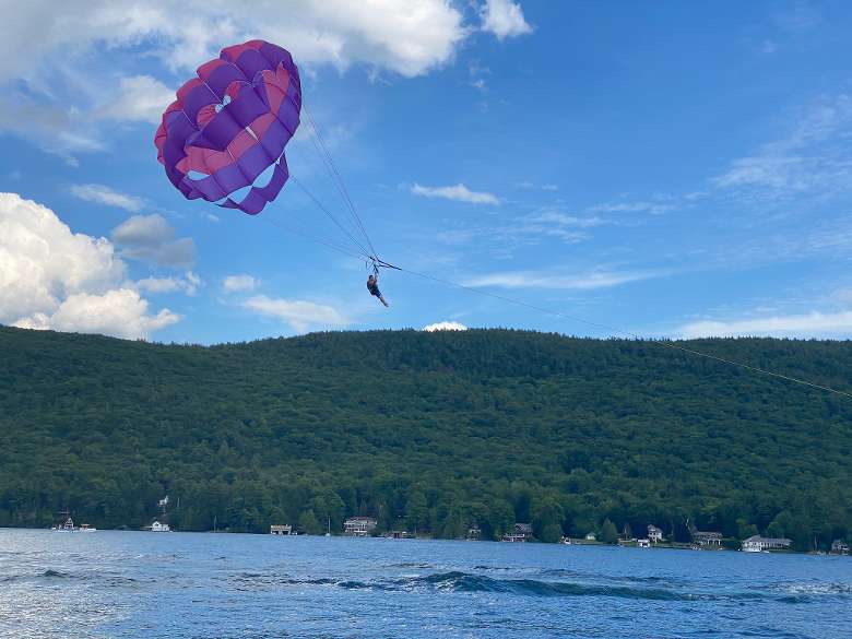 a person parasailing over a lake