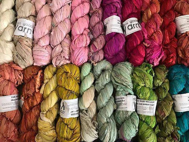 a bunch of different colored yarn
