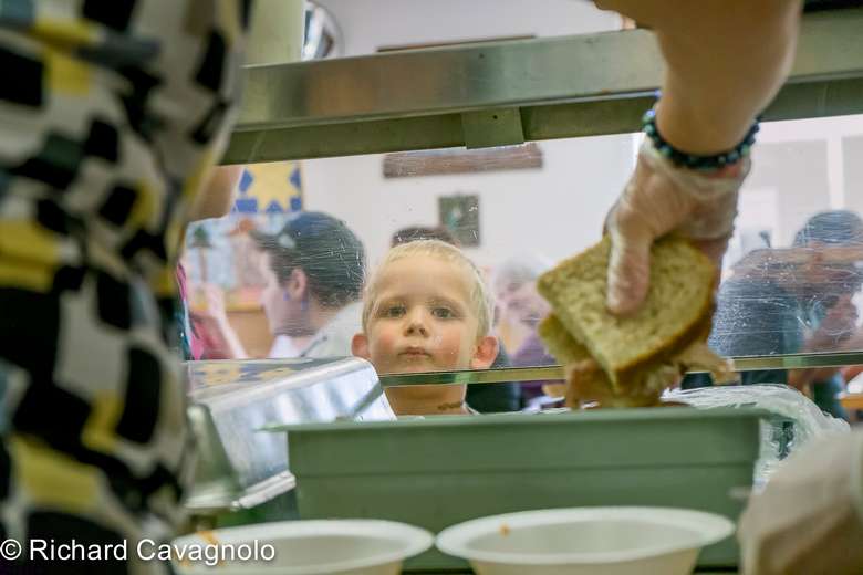 Woman serving a child food