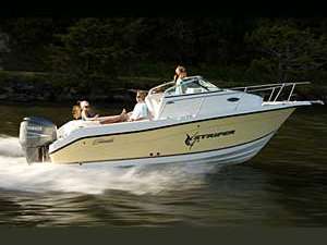 three people in a white and yellow motorboat that is speeding across the water