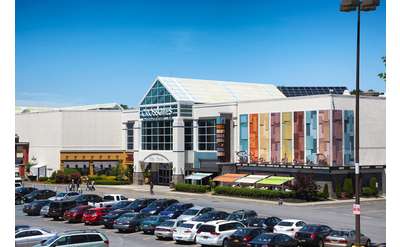 exterior of crossgates mall and the parking lot in front of it