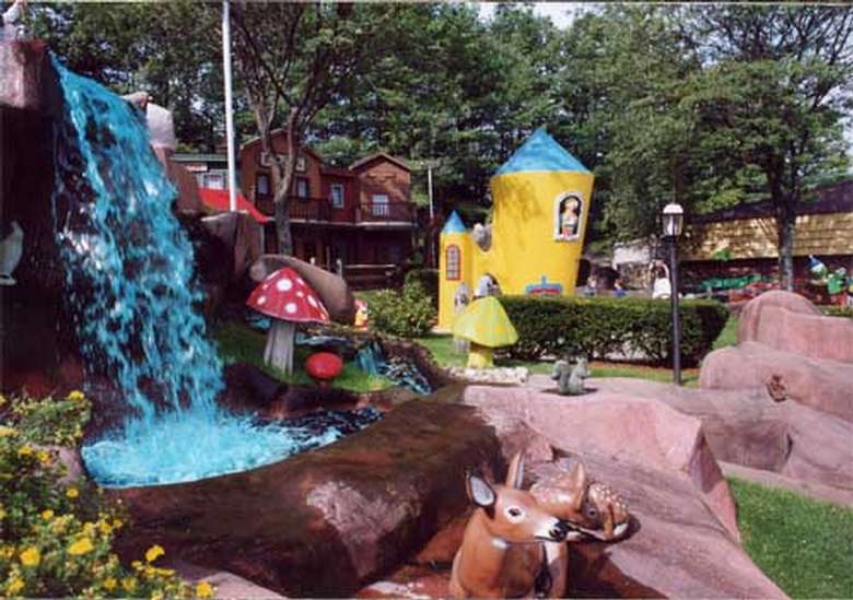 A waterfall and statues of deer, mushrooms, and a castle at Goony Golf