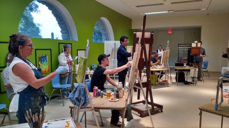 a room filled with people painting