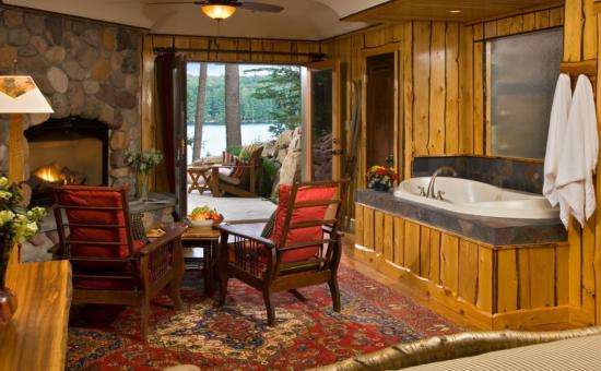 Guestroom "Forest" with a jacuzzi in the bedroom that views the fireplace and the Lakeview patio with its own fire pit