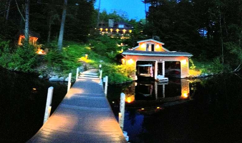 an evening pic of the dock and boathouse