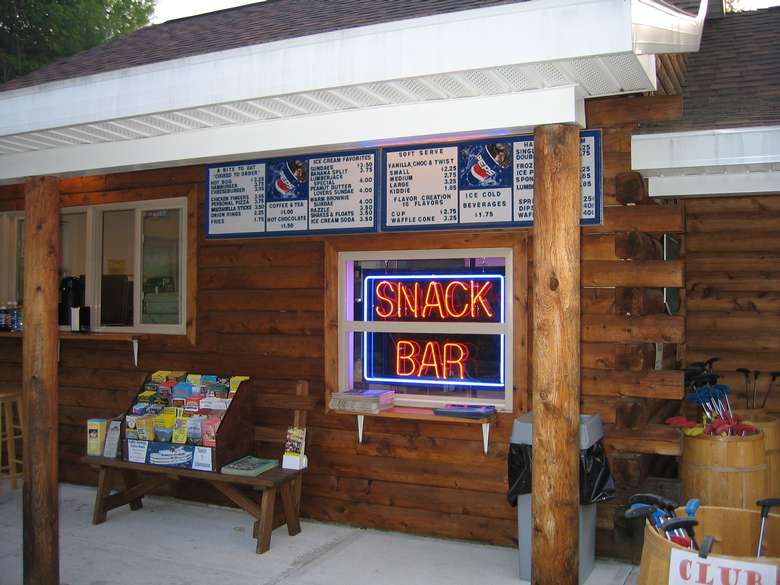 Snack Bar inside a log building with a neon sign