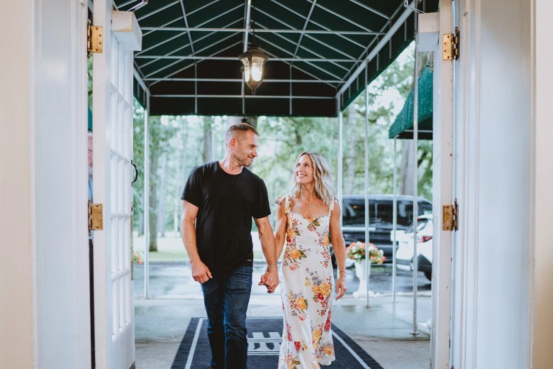 a man and woman walking into a hotel