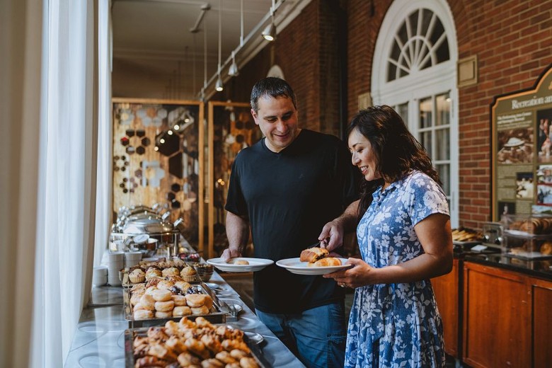 man and woman at a food station