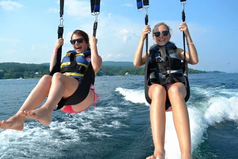 two young people parasailing