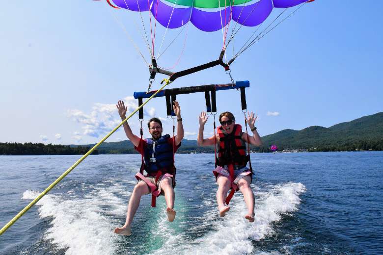 couple parasailing, about to be lifted up
