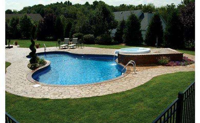 in-ground pool with a hot tub on a second level draining into the pool