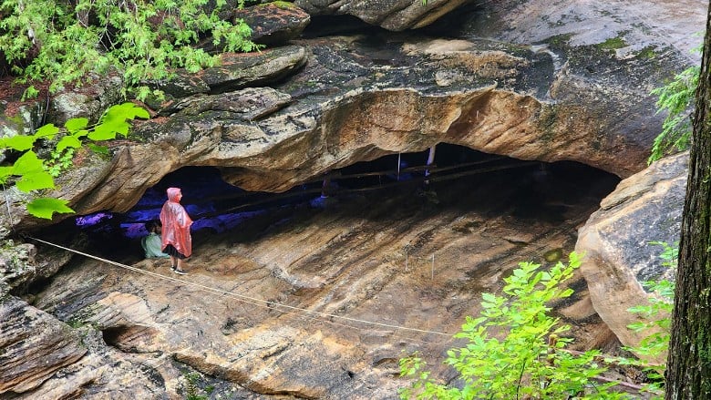 person by cave
