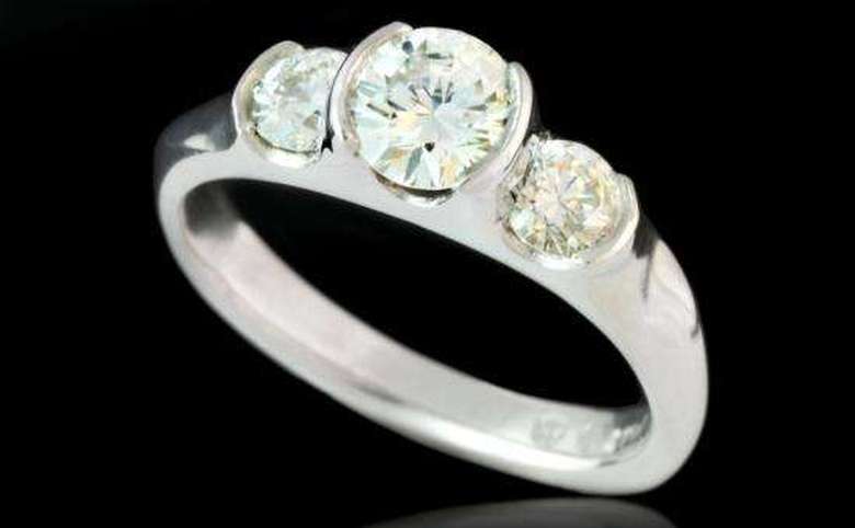three diamonds set in an engagement ring