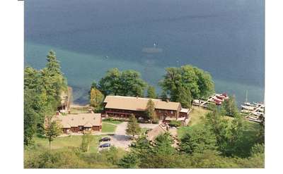 an aerial view of a brown motel near the waterfront