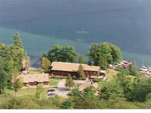 an aerial view of a brown motel near the waterfront