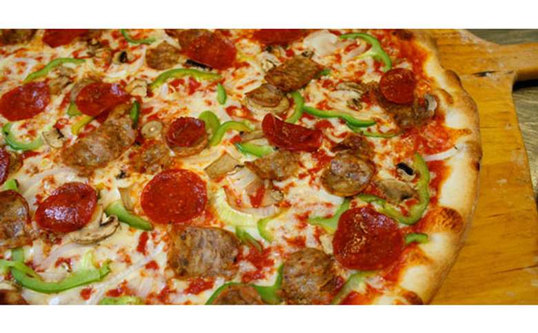 pizza with pepperoni, green peppers, onions, and sausage