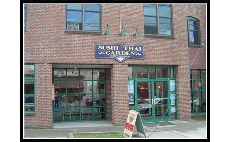 exterior of sushi thai garden, a brick building with large windows
