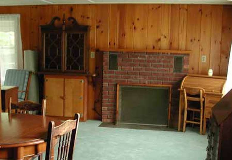 rustic paneled living room with fireplace