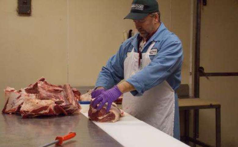 butcher preparing cuts of meat