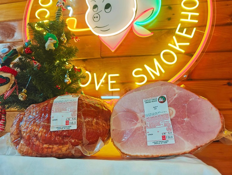 Two large packaged hams, one whole and one half, from Locust Grove Smokehouse.