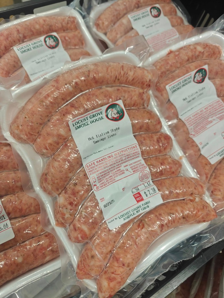 Packages of Locust Grove SmokeHouse Hot Italian Style Sausage Links in a refrigerated case.