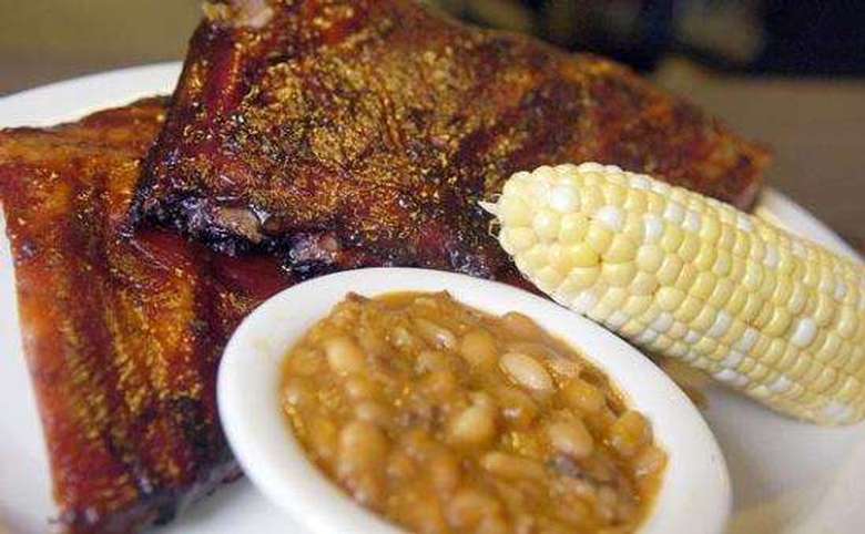 barbecue ribs, corn on the cob, and baked beans on a plate