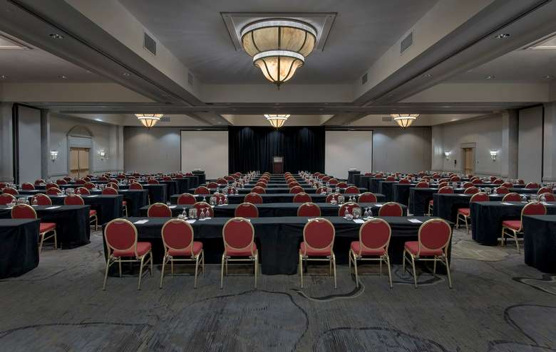 a large hotel event space with rows of chairs set up