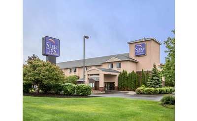 exterior of the sleep inn and suites with blue sky in the background