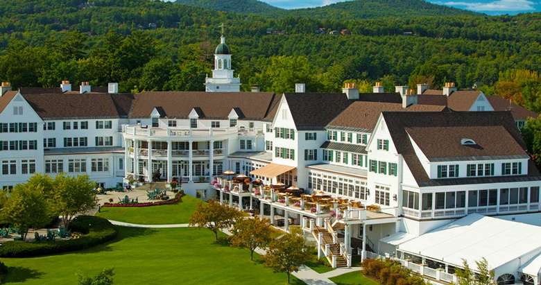 a large hotel with a green courtyard area.