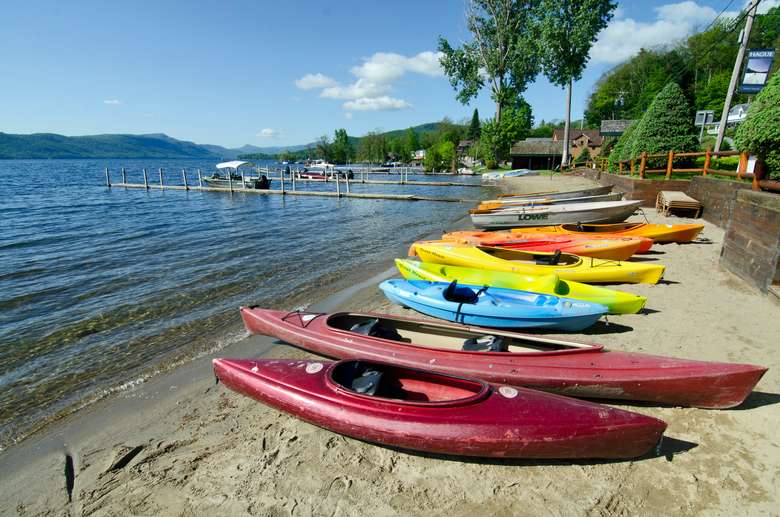 colorful kayaks lined up on a beach