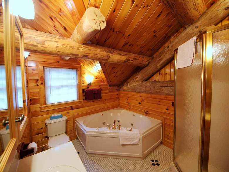 a fancy Adirondack-style bathroom with a jacuzzi tub