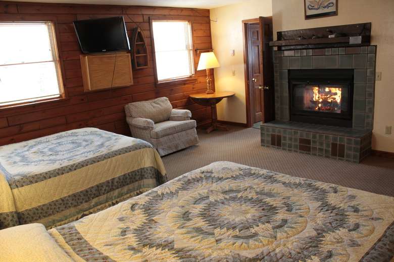 a fireplace in a bedroom with two beds