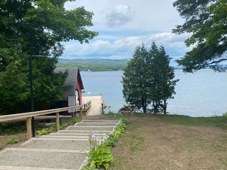 stairs leading down to a boat dock and lake