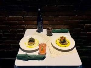 plates of food and cocktails on a dinner table