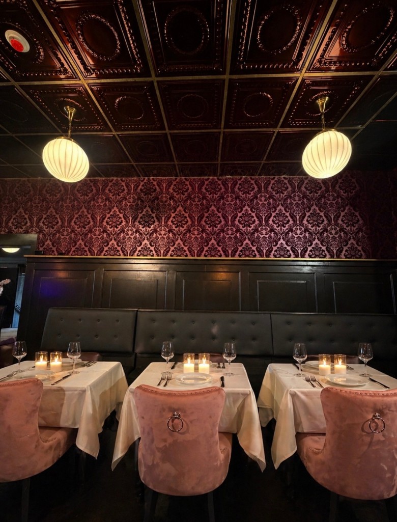 tables set up along a wall in a restaurant