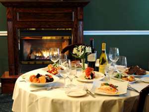 table in front of a fireplace at Lake Ridge Restaurant