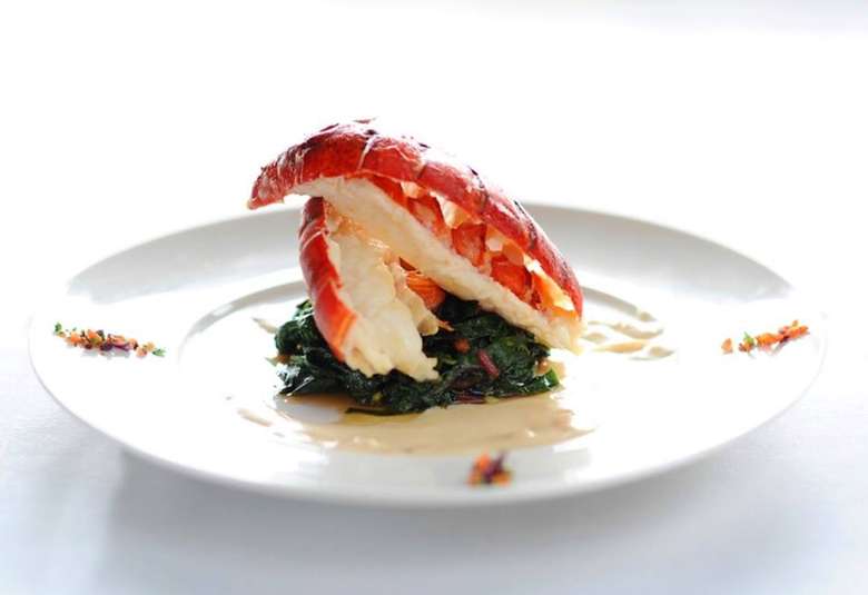 lobster Betty -- poached lobster tail over braised greens