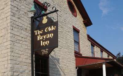 exterior of and sign for the olde bryan inn