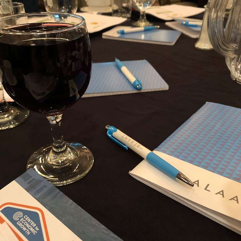 wine, notepads, pens on a table
